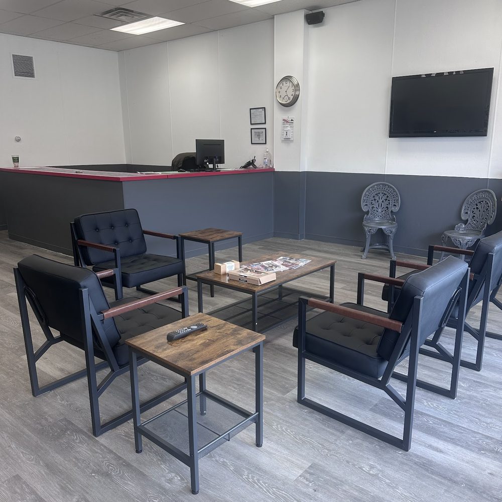 Comfortable customer waiting lounge with seating and TV at Ogden Auto Service